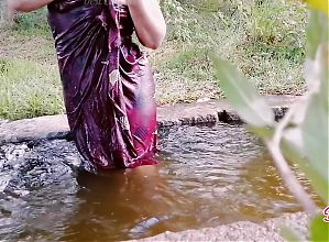 In The Outdoor, Desi Aunty is Naked and Crazy Fingering in the Water